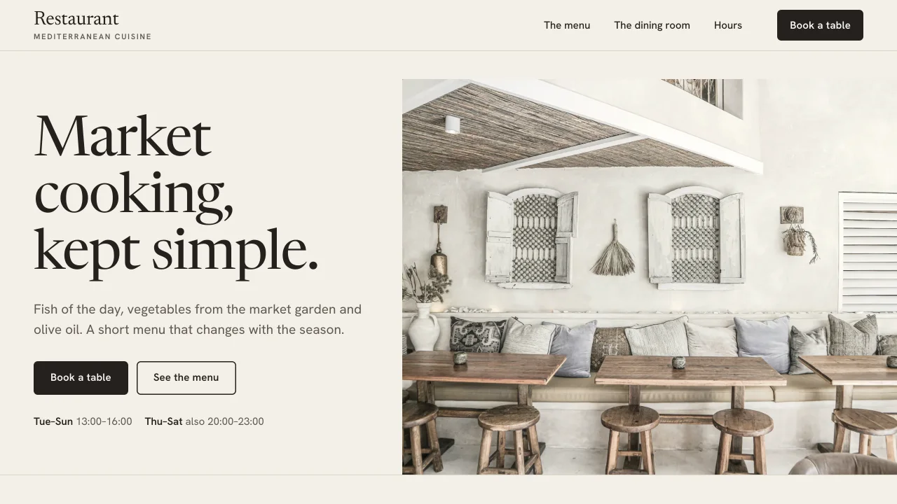 The restaurant concept on a computer: the opening with a large photo of the dining room, the text menu and the hours with the “Book a table” button.
